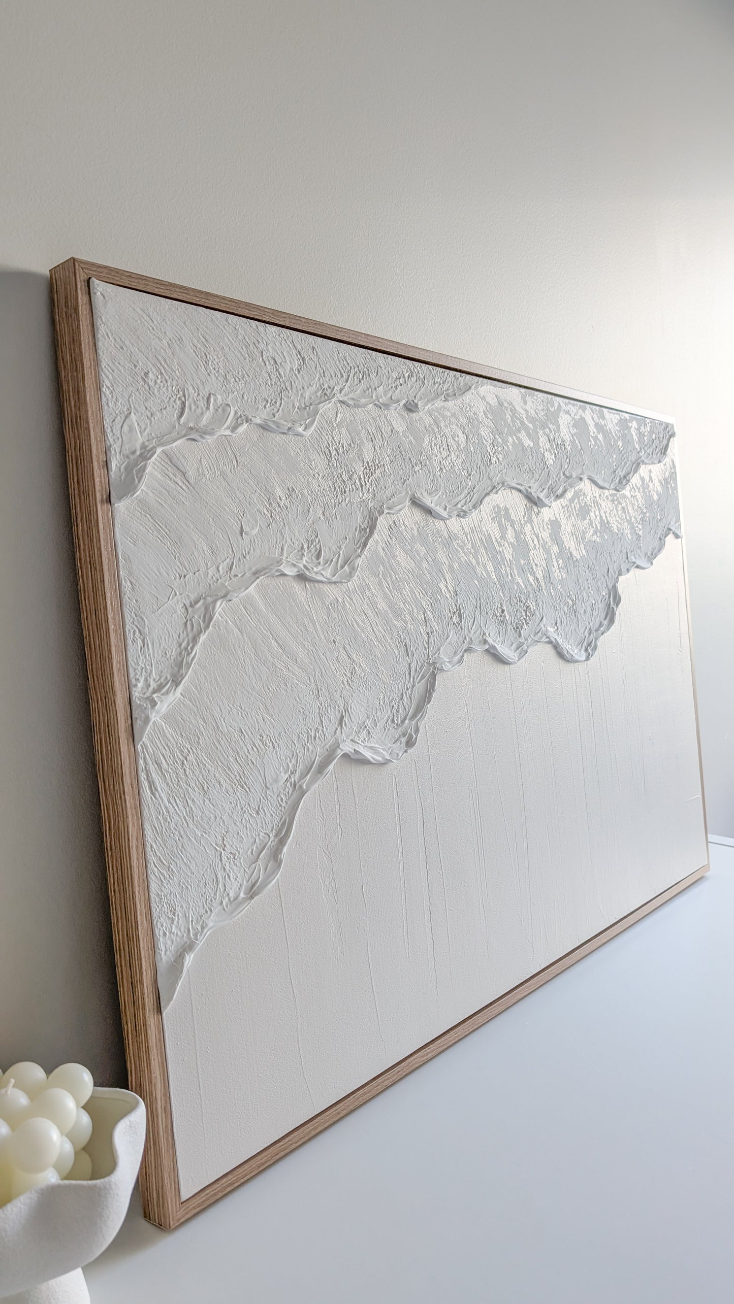 Ocean Wave Framed textured wall art on a white wall