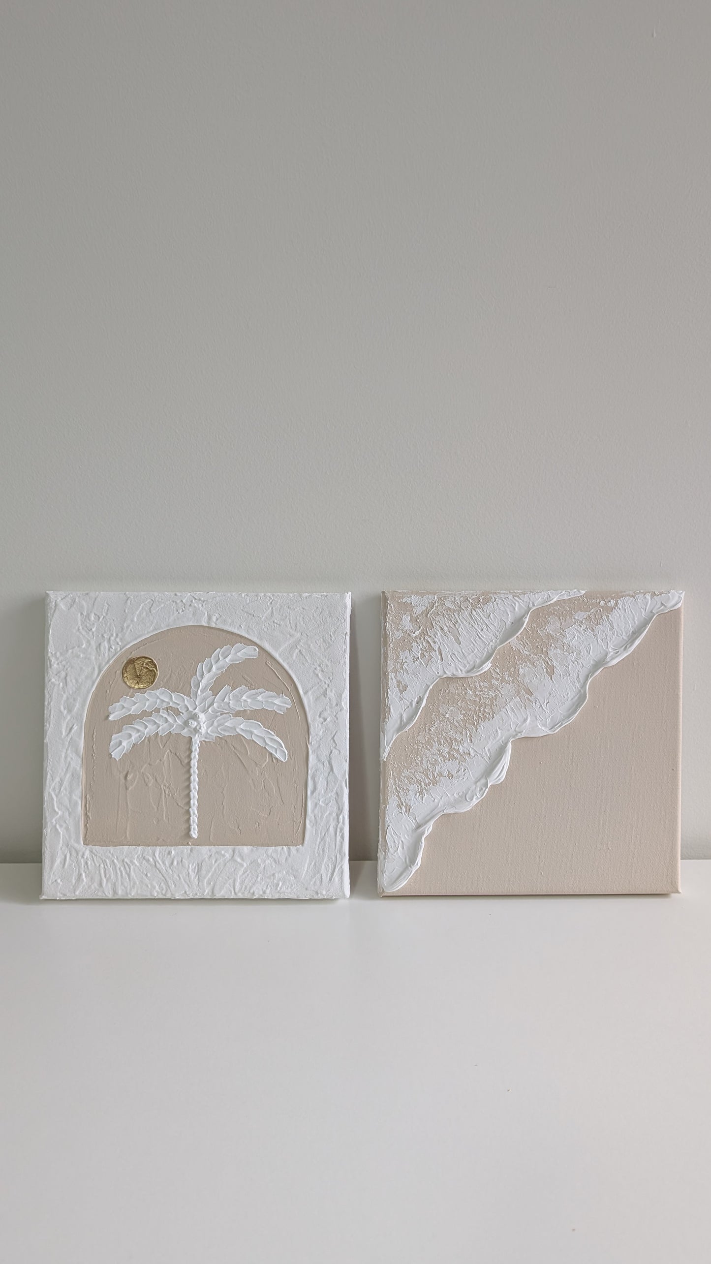 Two decorative panels with architectural and natural designs on a plain background