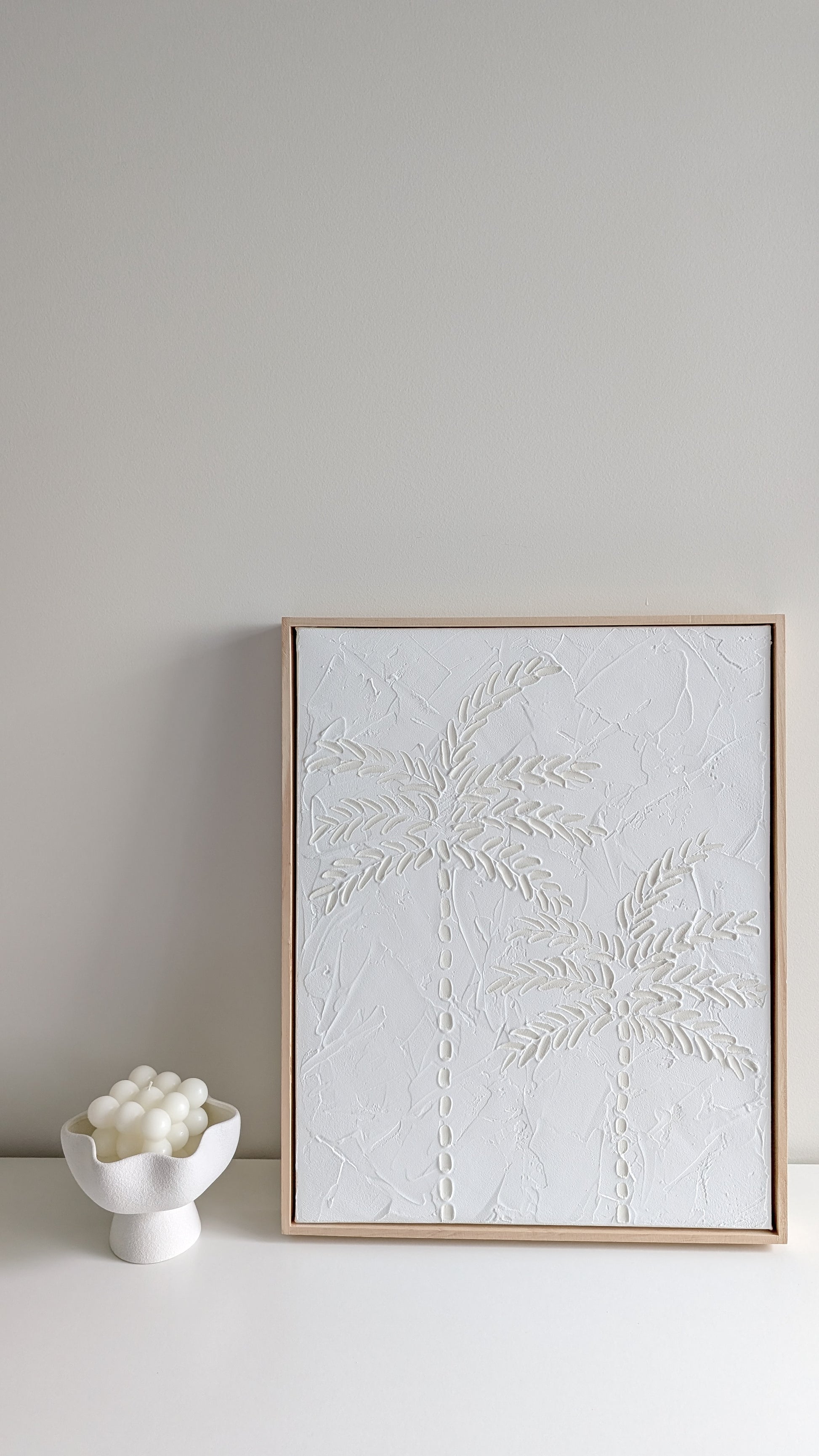 White textured coastal artwork resting on a shelf with neutral ceramic décor – handmade by Christen Rose