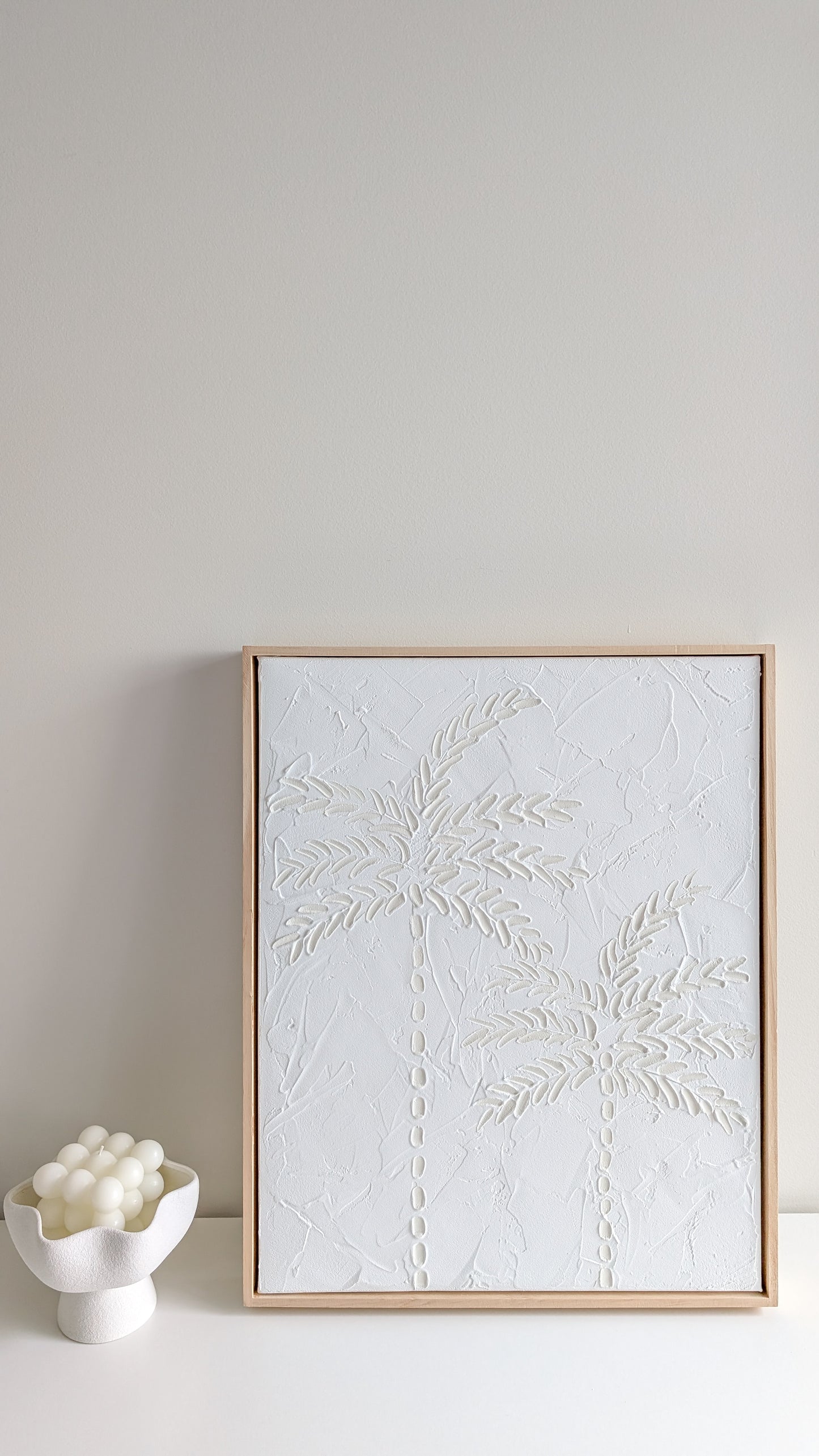 White minimalist textured artwork hanging on neutral wall with light timber frame – modern coastal wall décor by Christen Rose