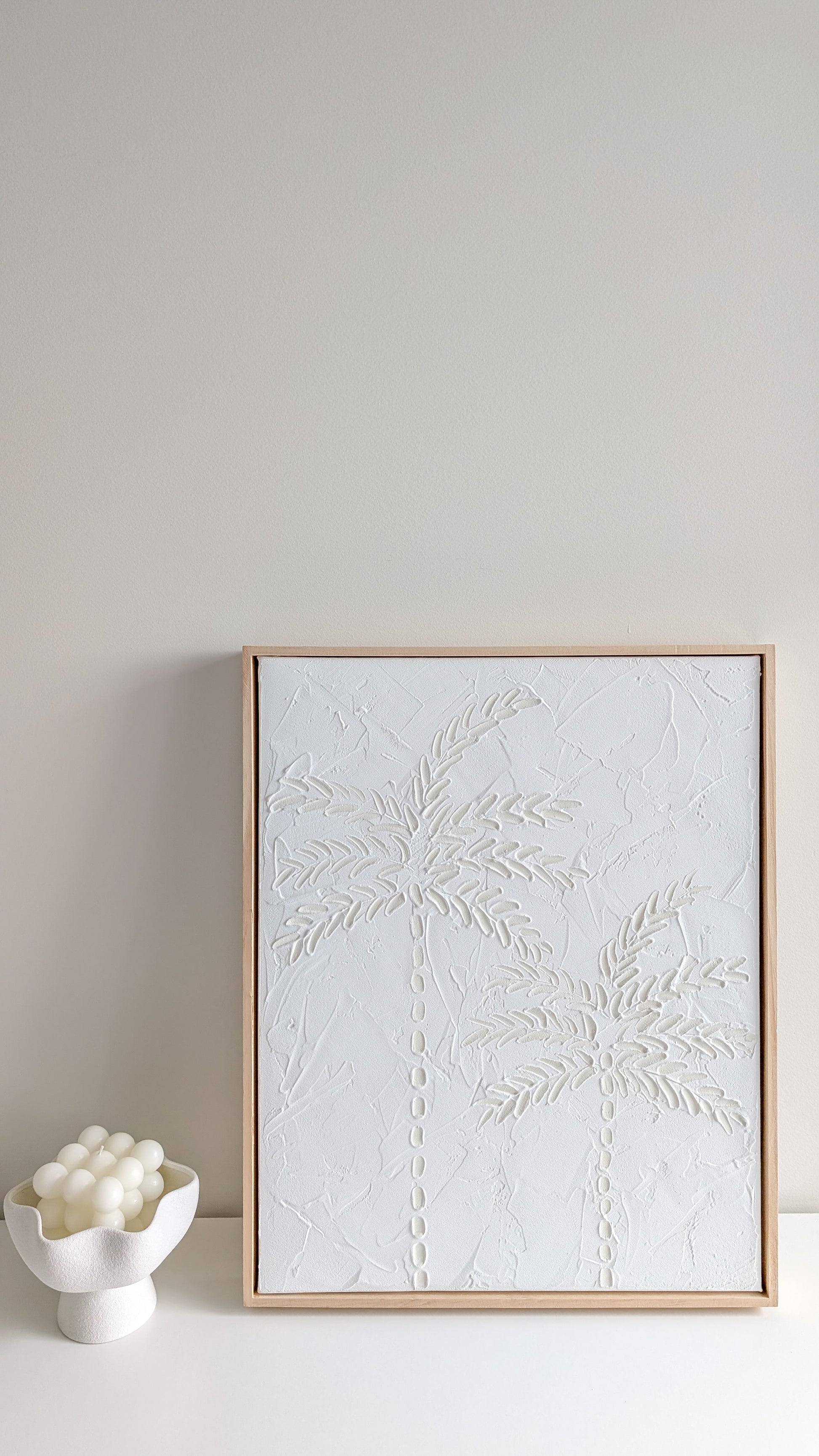 White minimalist textured artwork hanging on neutral wall with light timber frame – modern coastal wall décor by Christen Rose