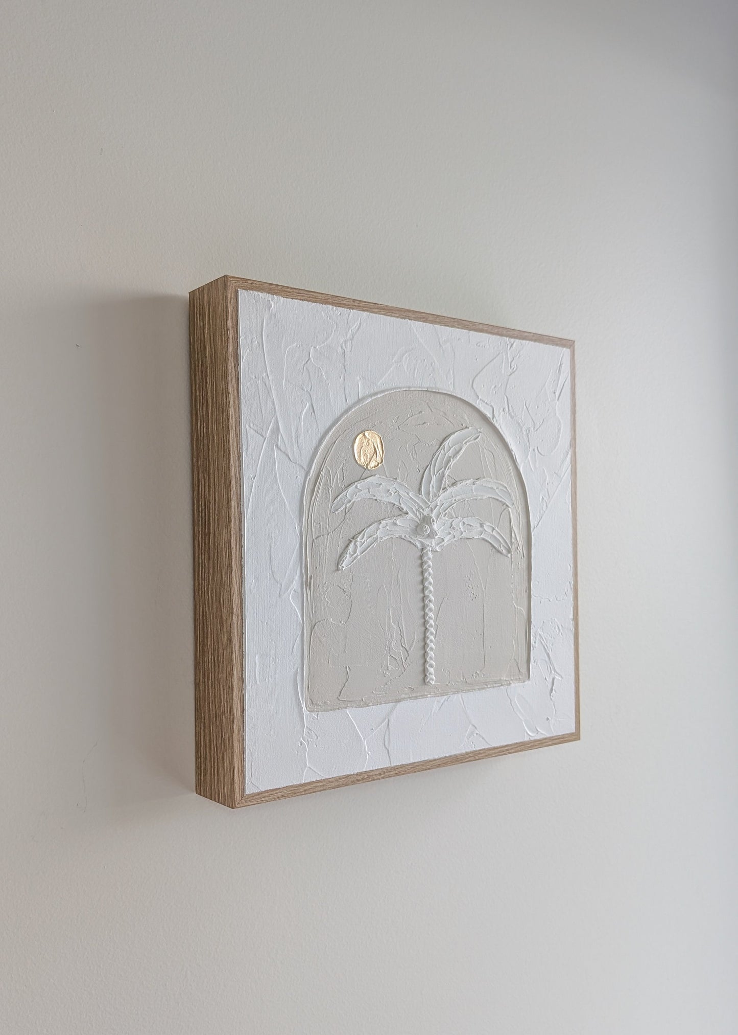 Side profile of palm tree textured artwork showing raised design and timber frame