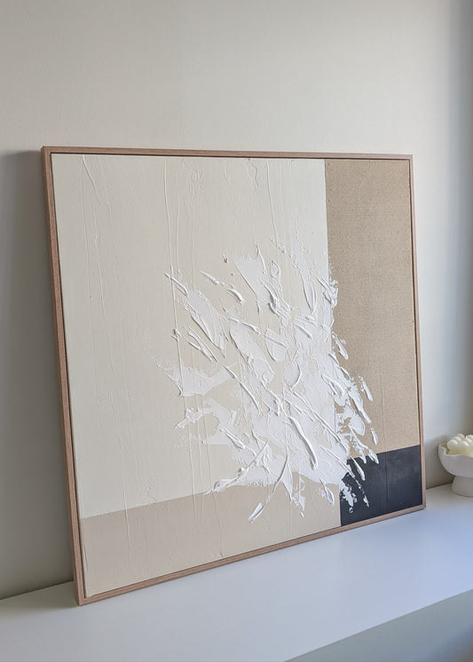 Abstract art piece with white abstract strokes on a beige background, framed in a neutral wood 