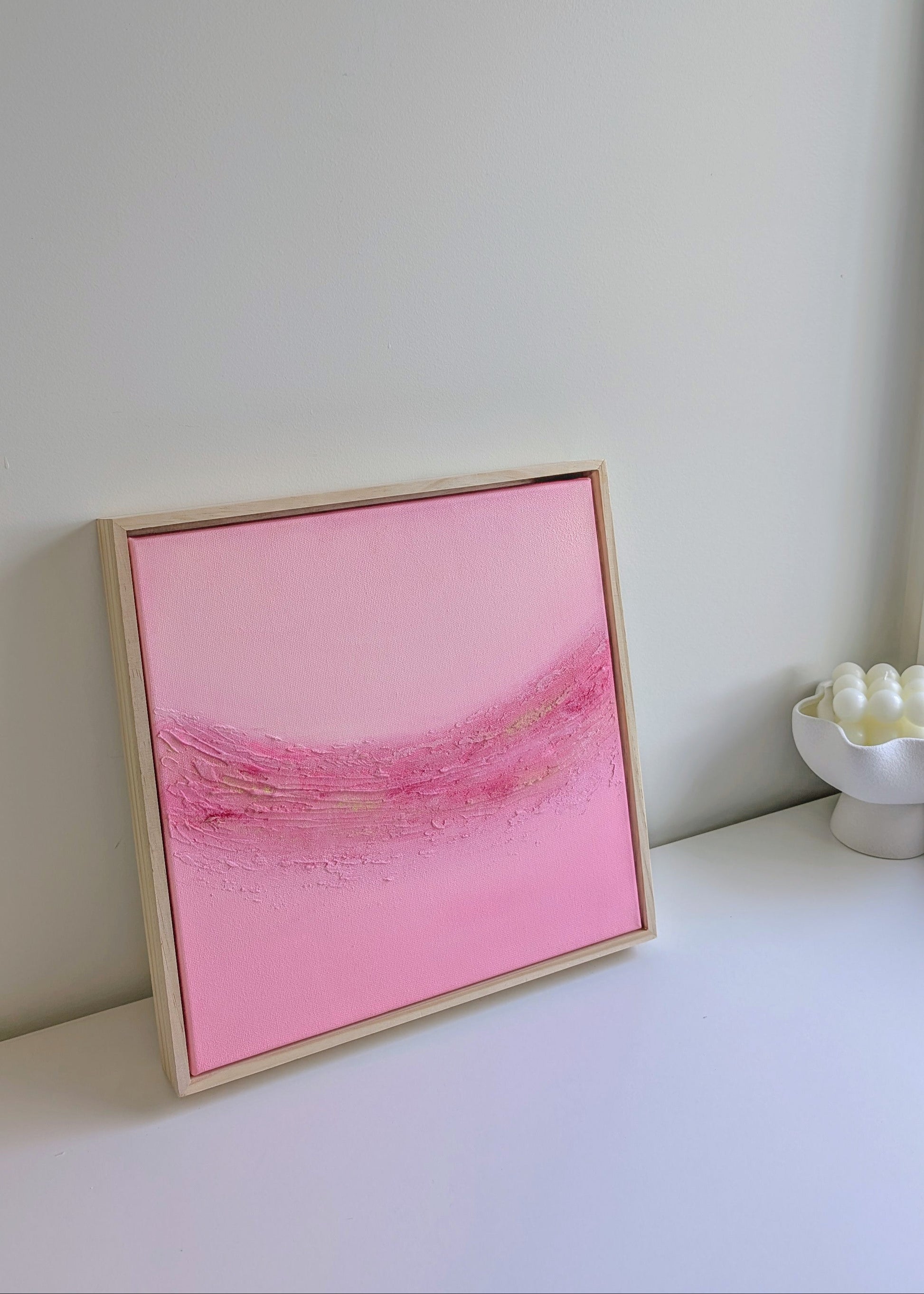 Framed pink textured abstract artwork titled "Blush Horizon" by Christen Rose, displayed on a white surface with natural light.