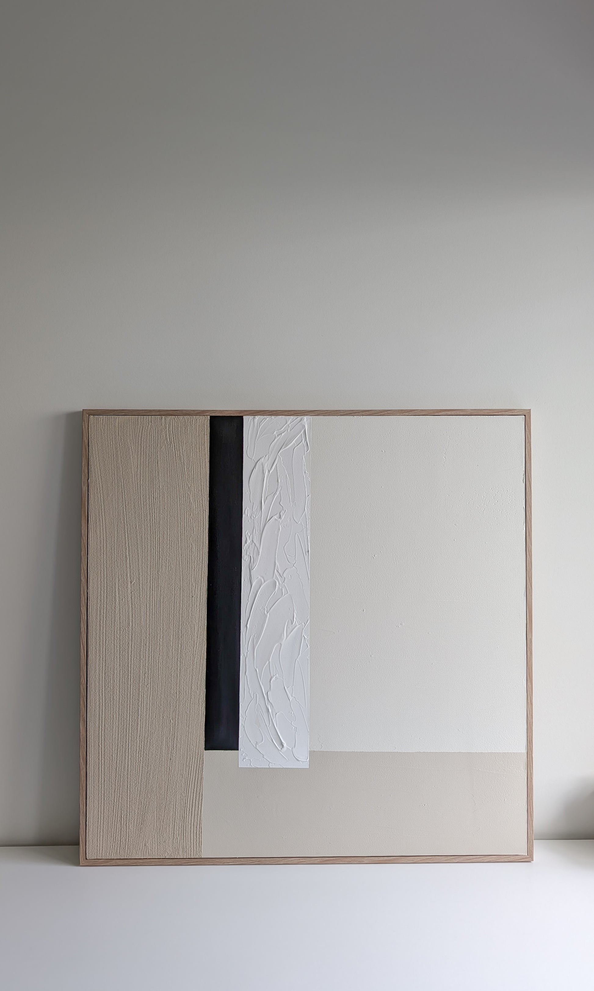 wabi sabi minimalist wall art with a wooden frame on a plain wall