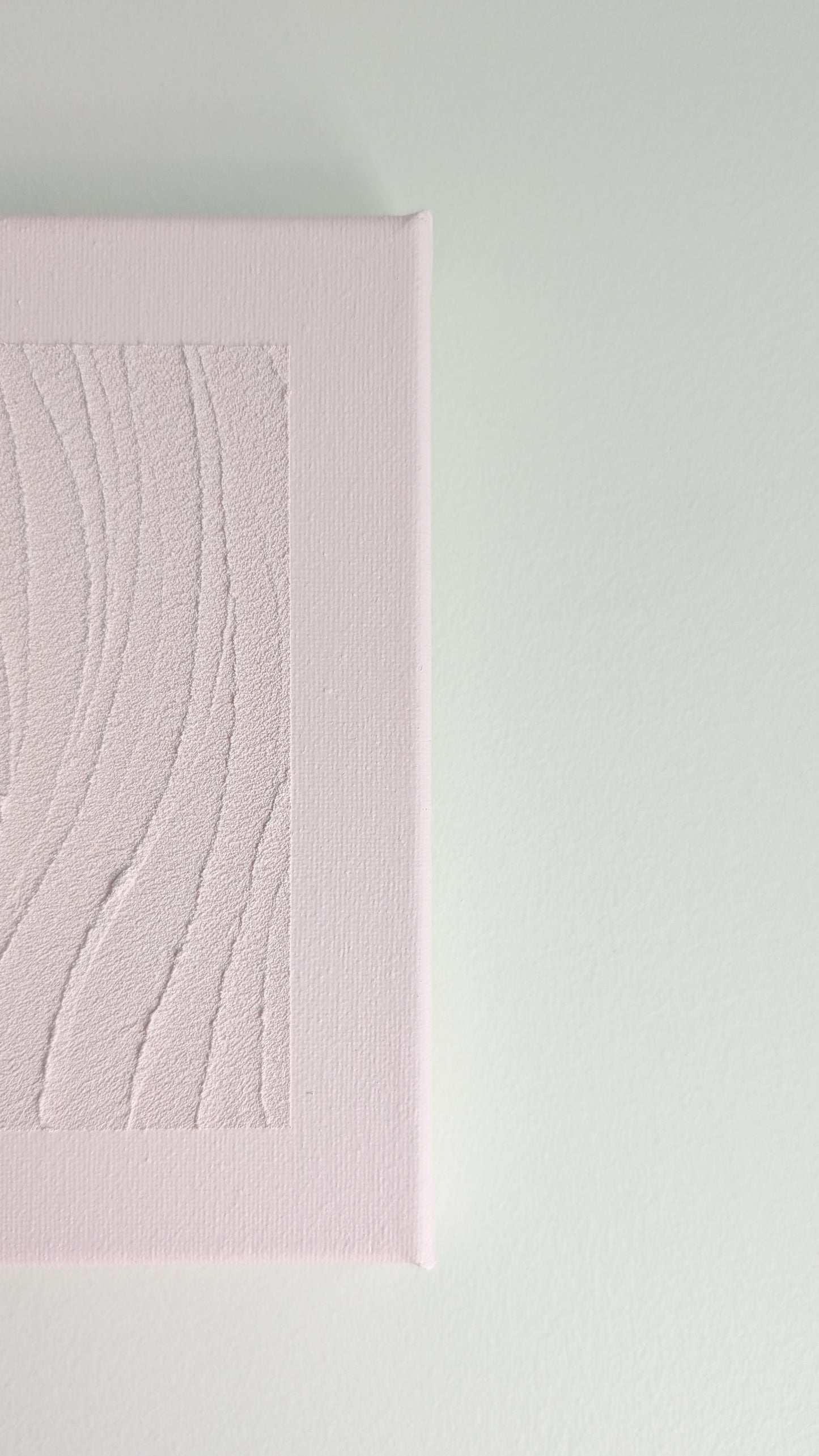 Pink textured wall art on a light gray background