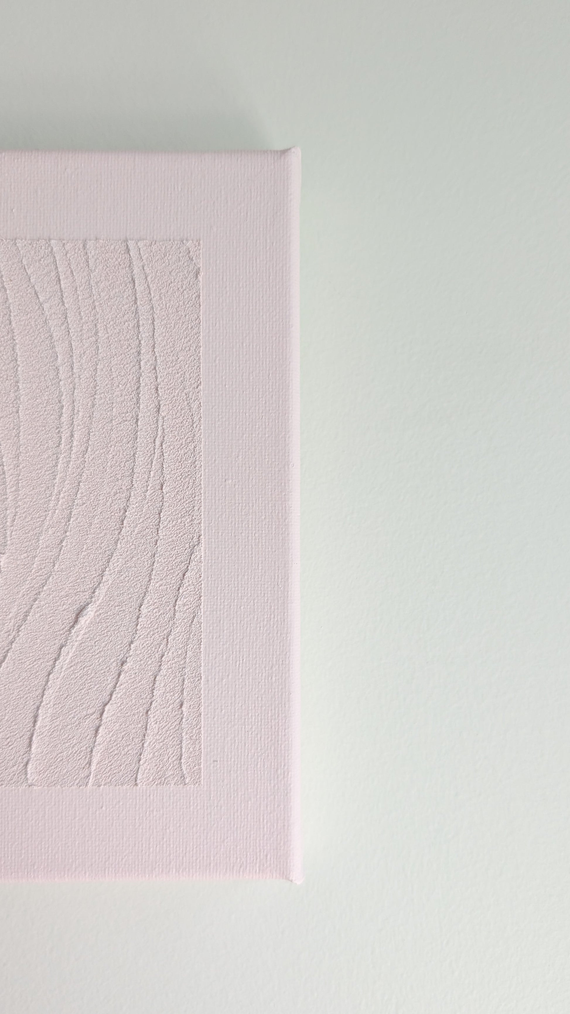 Pink textured wall art on a light gray background