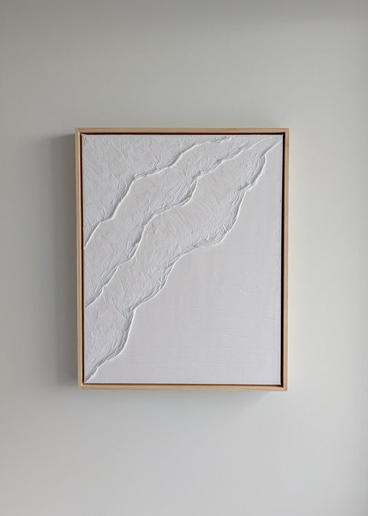 White minimalist textured artwork hanging on a neutral wall, framed in light timber – handmade coastal art by Christen Rose