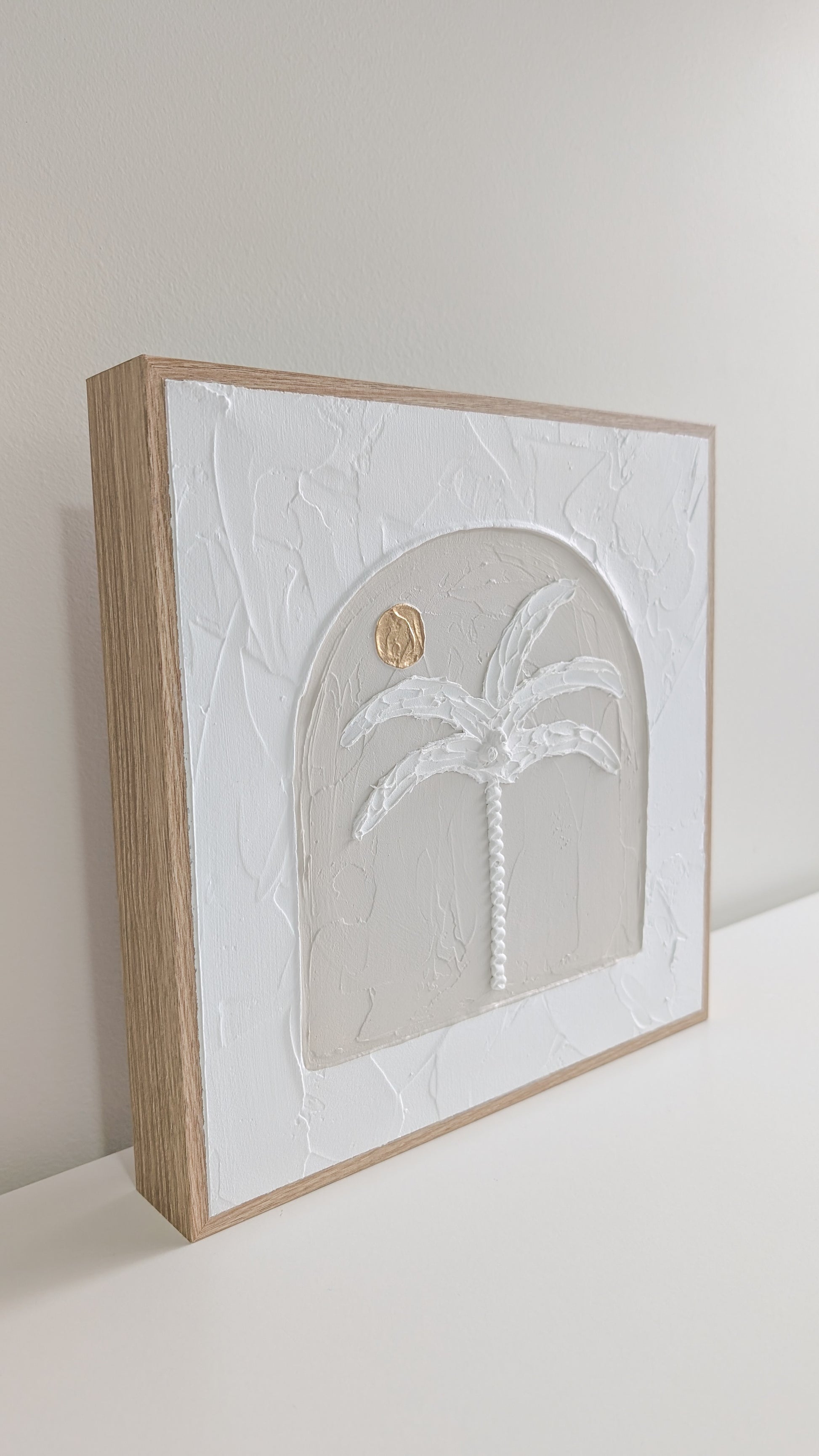 Minimalist palm tree artwork with textured 3D design and soft beige tones, front view