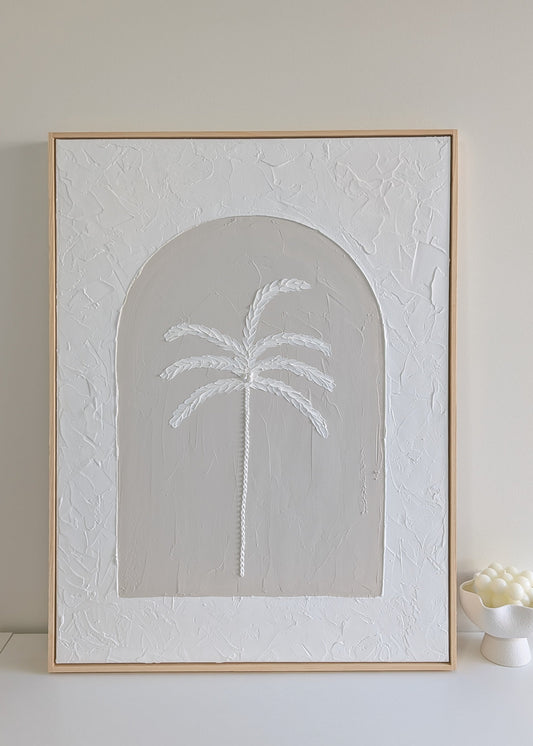 Textured palm tree wall art on large neutral canvas with arched design and raw pinewood frame, displayed on a white shelf in natural light.
